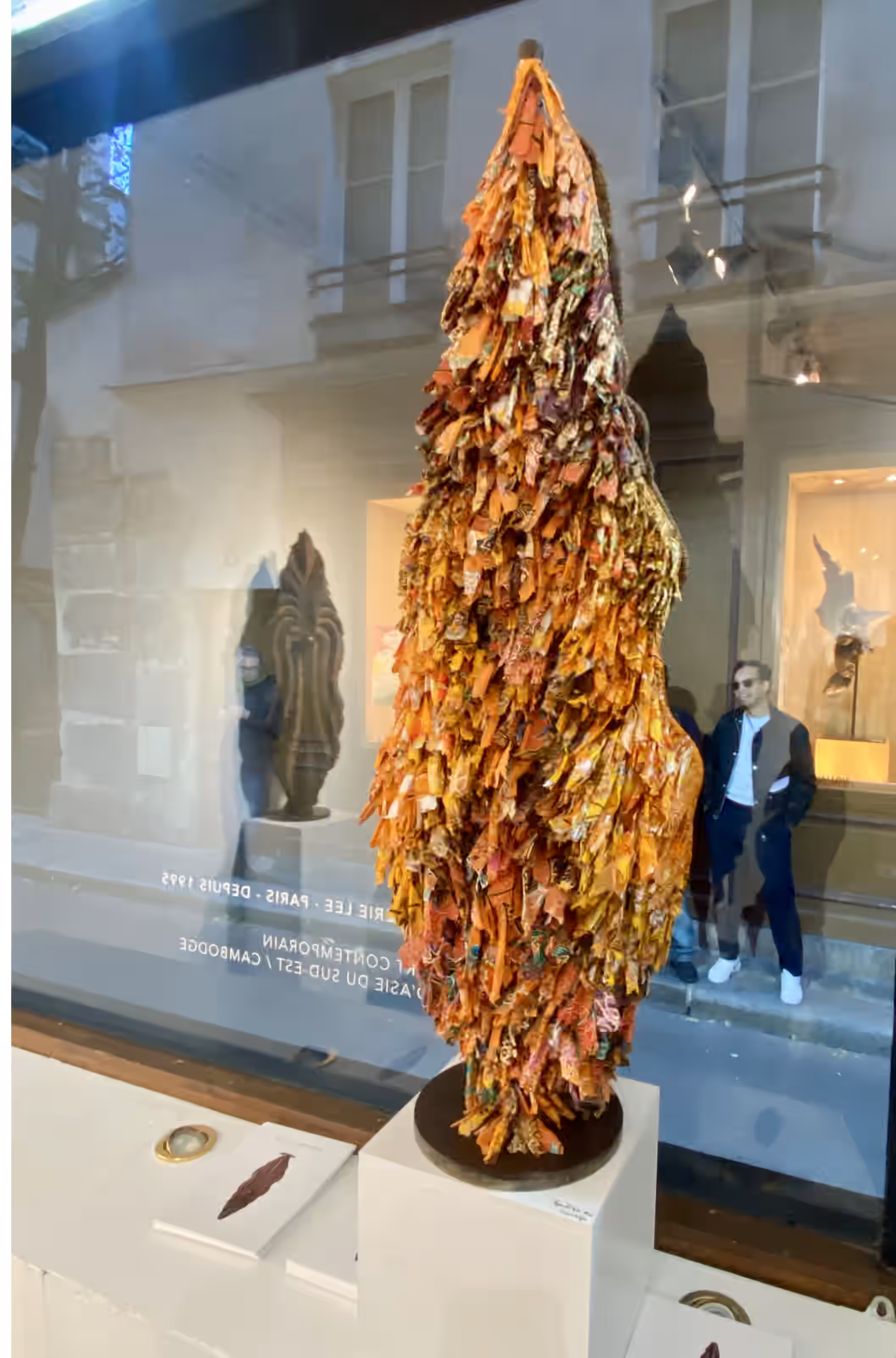 Orange sarong Keeper by Sothea Thang, seen from behind in the Galerie Lee window